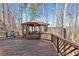 Elevated wooden deck with a gazebo and a grill, providing a perfect outdoor retreat with scenic views at 340 Ruby Forest Pkwy, Suwanee, GA 30024