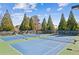 Well-maintained tennis courts with lights for evening play and viewing benches at 340 Ruby Forest Pkwy, Suwanee, GA 30024