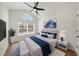 Stylishly decorated bedroom with vaulted ceiling, ceiling fan, accent furniture, and ample natural light at 404 Paperbark Ct, Acworth, GA 30102