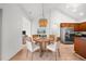 Dining room featuring modern chandelier, and view to kitchen and living room at 404 Paperbark Ct, Acworth, GA 30102