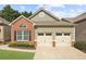 Charming home featuring a brick facade, two-car garage, and well-maintained lawn at 404 Paperbark Ct, Acworth, GA 30102