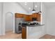 Open kitchen featuring stainless steel appliances, a breakfast bar, and modern pendant lighting at 404 Paperbark Ct, Acworth, GA 30102