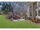 Backyard patio with stone fireplace and outdoor seating, set in a lush, wooded landscape at 455 Emerald Lake Path, Sugar Hill, GA 30518