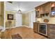 Entertainment bar area featuring wine storage, hardwood floors, and stylish cabinetry at 455 Emerald Lake Path, Sugar Hill, GA 30518