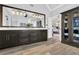 Elegant bathroom featuring a double vanity, wood-look floors, and a view to the Primary bedroom at 455 Emerald Lake Path, Sugar Hill, GA 30518