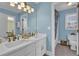 Bathroom features a double sink vanity, white cabinets, and a large mirror at 455 Emerald Lake Path, Sugar Hill, GA 30518