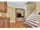 Bonus room with hardwood floors and staircase, featuring a brick archway leading to the Gathering room at 455 Emerald Lake Path, Sugar Hill, GA 30518