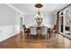 Formal dining room with hardwood floors, traditional furnishings, chandelier, and natural light at 455 Emerald Lake Path, Sugar Hill, GA 30518