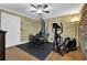 A well-equipped home gym features modern exercise equipment, hardwood floors, and a ceiling fan at 455 Emerald Lake Path, Sugar Hill, GA 30518