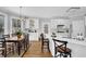 An open-concept kitchen features a breakfast nook and white cabinets for ample storage at 455 Emerald Lake Path, Sugar Hill, GA 30518