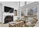 Bright living room with a fireplace, large windows, and built-in shelving for an inviting atmosphere at 455 Emerald Lake Path, Sugar Hill, GA 30518