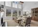 Cozy living room with high ceilings, large windows, fireplace, and comfortable furniture at 455 Emerald Lake Path, Sugar Hill, GA 30518