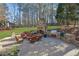 This outdoor kitchen features a stone fireplace, built-in grill, and comfortable seating area at 455 Emerald Lake Path, Sugar Hill, GA 30518