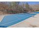 Private blue tennis court with net, surrounded by trees and landscaping at 455 Emerald Lake Path, Sugar Hill, GA 30518