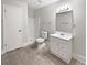 A bathroom featuring a tile floor, a standing shower, a toilet, and a single sink vanity at 6518 Voyles Dr, Riverdale, GA 30274