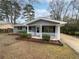 Quaint single-Gathering home with covered porch and manicured yard at 6518 Voyles Dr, Riverdale, GA 30274