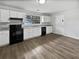 Kitchen with modern appliances, white cabinets, new countertops, and hardwood floors at 6518 Voyles Dr, Riverdale, GA 30274