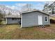 A lovely rear exterior with light blue siding, a white door, and a lush green lawn surrounding at 6518 Voyles Dr, Riverdale, GA 30274