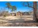 Expansive backyard with a well-maintained lawn and mature trees surrounding brick home at 345 Wedgefield Dr, Mcdonough, GA 30252