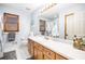 Bright bathroom with wooden cabinets, long countertop, and plenty of lighting at 345 Wedgefield Dr, Mcdonough, GA 30252