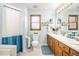 Bathroom with double vanity, blue walls, and a shower with curtain at 345 Wedgefield Dr, Mcdonough, GA 30252