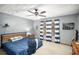 Cozy bedroom featuring blue bedding, ceiling fan, and natural light at 345 Wedgefield Dr, Mcdonough, GA 30252