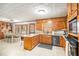 Open concept kitchen features a breakfast bar and dining area with wood cabinets, offering ample space at 345 Wedgefield Dr, Mcdonough, GA 30252