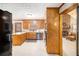 Open kitchen with stainless appliances, wooden cabinetry, connecting seamlessly to a cozy living room with fireplace at 345 Wedgefield Dr, Mcdonough, GA 30252