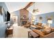 Spacious living room with a striking brick fireplace, high ceilings, and comfortable leather furniture at 345 Wedgefield Dr, Mcdonough, GA 30252