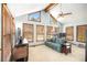 Bright living room with vaulted ceilings, large windows, and a comfortable sofa, creating an inviting space at 345 Wedgefield Dr, Mcdonough, GA 30252