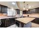 Updated kitchen with butcher block island, stainless steel appliances, and under cabinet lighting at 3701 W County Line Rd, Douglasville, GA 30135