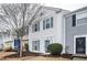 Charming two-story townhouse featuring blue shutters and well-maintained landscaping, creating inviting curb appeal at 3994 Wolcott Cir, Atlanta, GA 30340