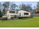 Beautifully landscaped backyard with a spacious lawn, modern deck and seating area, ideal for outdoor living at 4217 Paces Ferry Se Rd, Atlanta, GA 30339