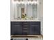 Bathroom featuring a dual sink vanity with gold hardware and a marble-tiled shower at 4217 Paces Ferry Se Rd, Atlanta, GA 30339