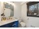 Stylish bathroom featuring a gold-framed mirror, blue vanity, and modern fixtures at 4217 Paces Ferry Se Rd, Atlanta, GA 30339