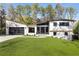 Charming two-story home featuring modern design, black framed windows, and a well-manicured lawn at 4217 Paces Ferry Se Rd, Atlanta, GA 30339