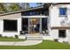 Beautiful front entrance with modern glass doors, black frames, steps, and elegant lighting at 4217 Paces Ferry Se Rd, Atlanta, GA 30339