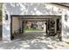 Spacious, open garage offering lots of room for parking and storage, showcasing a peek into the backyard shed at 4217 Paces Ferry Se Rd, Atlanta, GA 30339