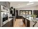 Modern kitchen with a breakfast bar, stainless steel appliances, and sleek dark cabinetry at 4217 Paces Ferry Se Rd, Atlanta, GA 30339