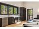 Modern kitchen area with stainless steel appliances, stone countertops, and dark wood cabinets at 4217 Paces Ferry Se Rd, Atlanta, GA 30339