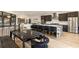 Open kitchen and dining area featuring waterfall island, stainless appliances, and ample seating at 4217 Paces Ferry Se Rd, Atlanta, GA 30339