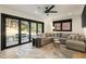Spacious living room showcasing a sectional sofa, large windows, and a door to the outdoor space at 4217 Paces Ferry Se Rd, Atlanta, GA 30339