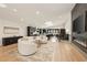 Open concept living area with a fireplace, hardwood floors, modern furniture, and lots of natural light at 4217 Paces Ferry Se Rd, Atlanta, GA 30339