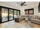 Spacious living room showcasing a sectional sofa, large windows, and a door to the outdoor space at 4217 Paces Ferry Se Rd, Atlanta, GA 30339