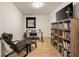 Home office with a glass top desk, comfortable chair, and a full wall of bookshelves at 4217 Paces Ferry Se Rd, Atlanta, GA 30339
