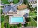 Aerial view of community amenities, featuring multiple pools, landscaping and a community center at 1411 Wisteria Wall Dr, Suwanee, GA 30024