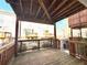Wooden back porch overlooking a green space with other houses visible at 1411 Wisteria Wall Dr, Suwanee, GA 30024
