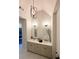 Bright bathroom with dual vanities, modern fixtures, and stylish pendant lighting at 1411 Wisteria Wall Dr, Suwanee, GA 30024