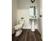 Half bathroom with a pedestal sink and modern fixtures at 1411 Wisteria Wall Dr, Suwanee, GA 30024