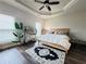 Well-lit bedroom with a wood-frame bed and stylish accents at 1411 Wisteria Wall Dr, Suwanee, GA 30024
